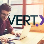 person at computer with Vertx logo