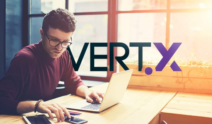 person at computer with Vertx logo