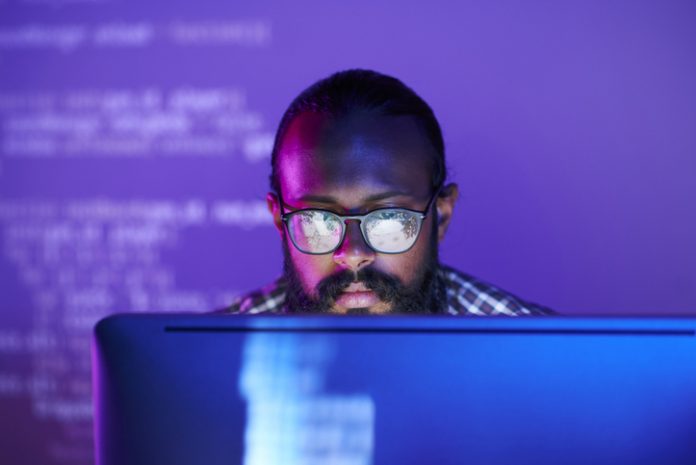 Programmer in front of monitor
