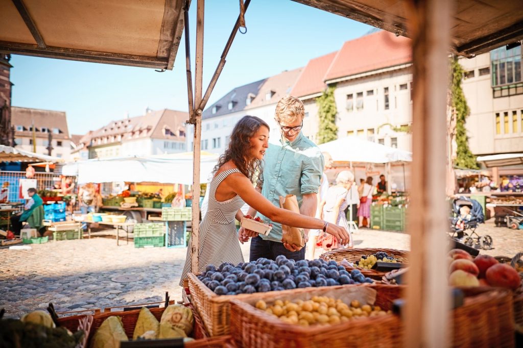 Do you need an API Marketplace? Couple shop at outdoor summer fruit market