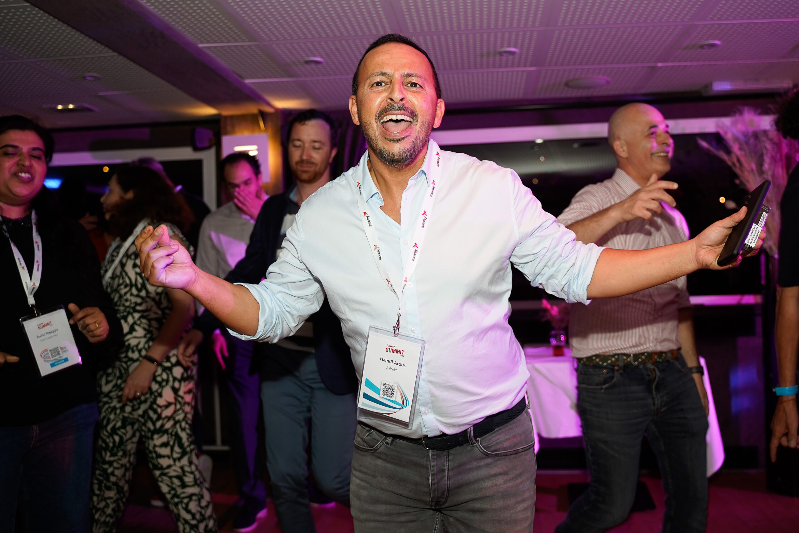Attendees dancing and singing along at Axway Summit 2024 in Lyon, France