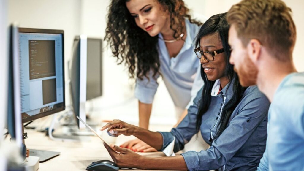 A group of people looking at a computer screen