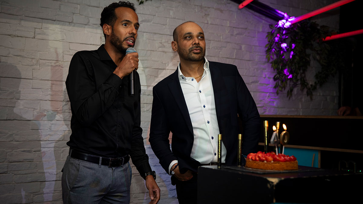 Didier Dabon and Meetesh Patel with birthday cake talking