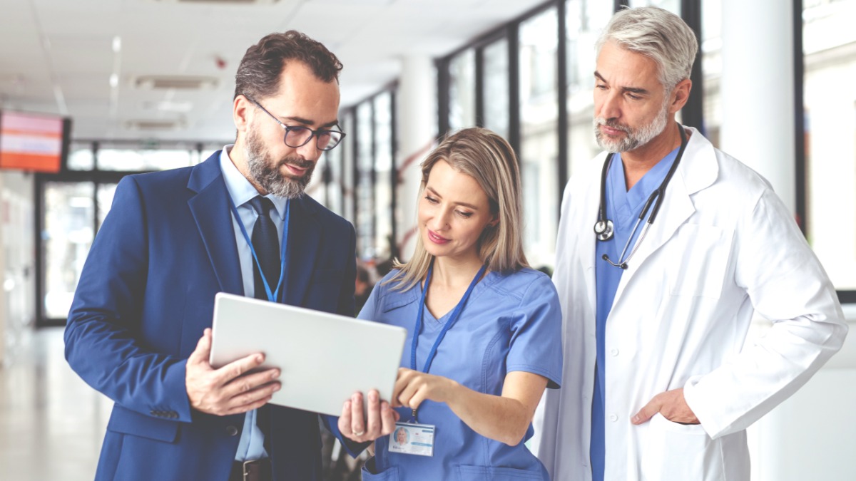 doctors looking at a mobile device in a hospital