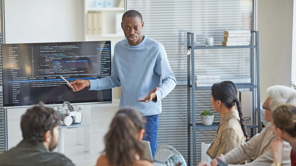 A man giving a presentation to his colleagues