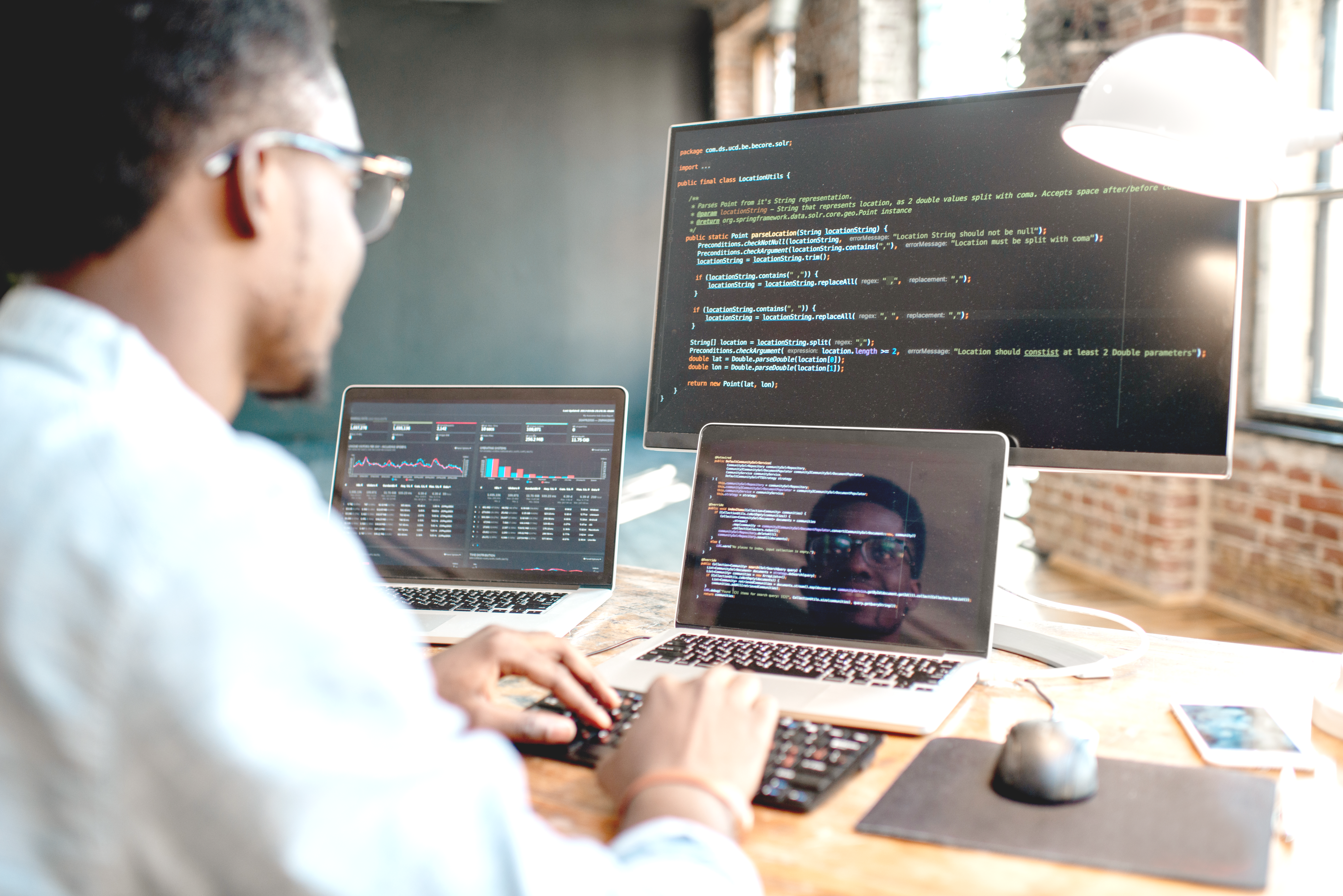 A web developer looking at the lines of code on his computer