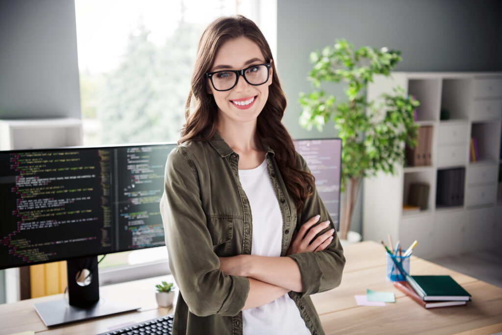 Photo of confident smiling lady admin wear spectacles arms folded creating new application indoors workplace workshop.