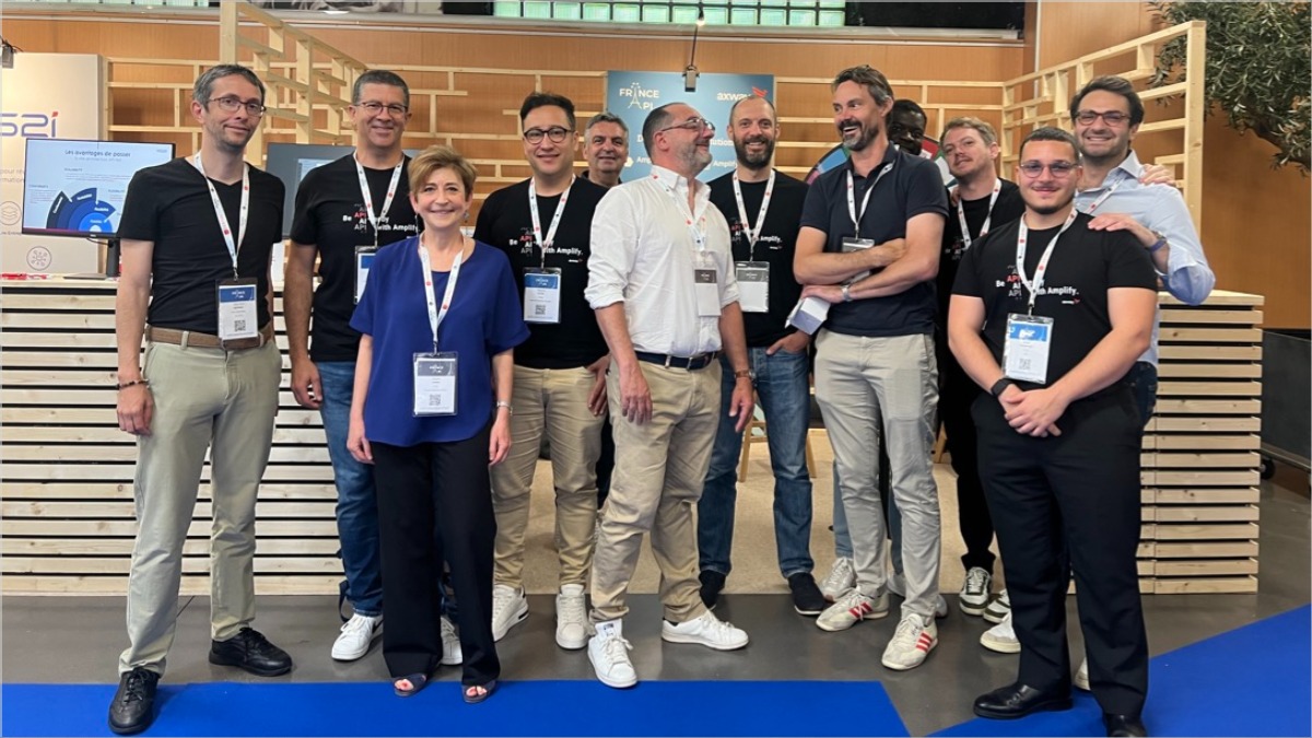 Group of participants at the France API event, posing for a photo in a professional setting.
