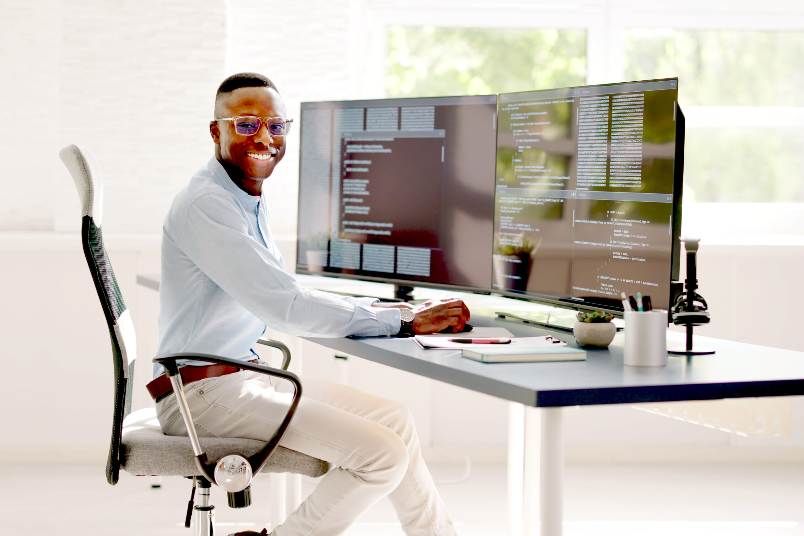 African American Coder Using Computer At Desk. Web Developer