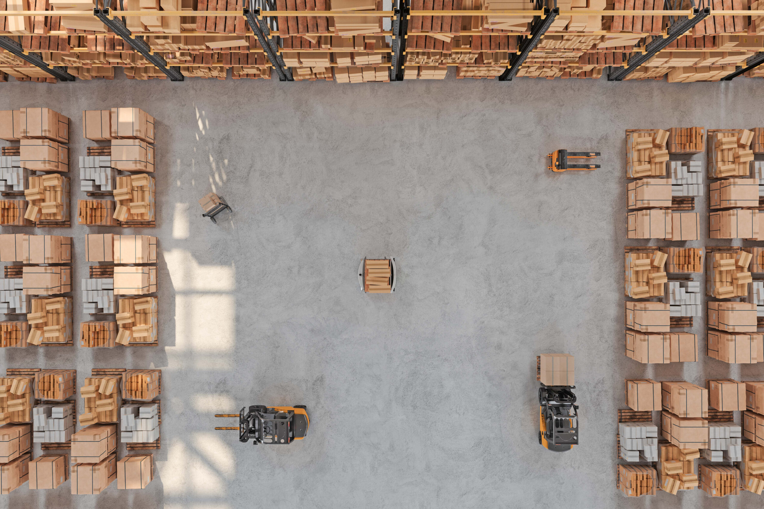 Aerial view of a warehouse with shelves stacked with boxes and multiple forklifts moving pallets across an open concrete floor.
