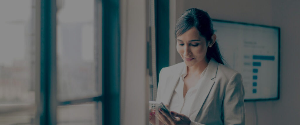 Woman with black hair and a blazer in an office