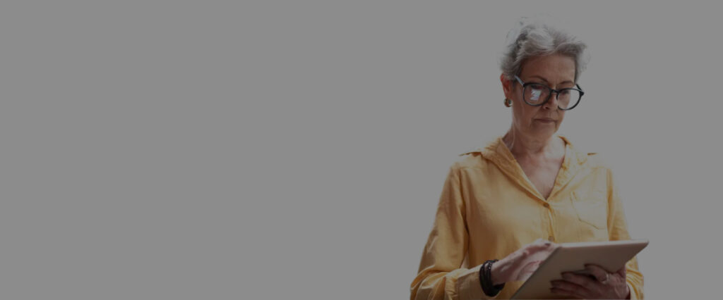 woman with yellow shirt looking at an ipad