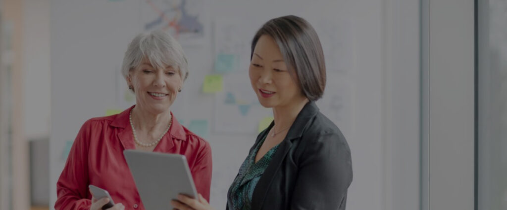two women looking at a tablet